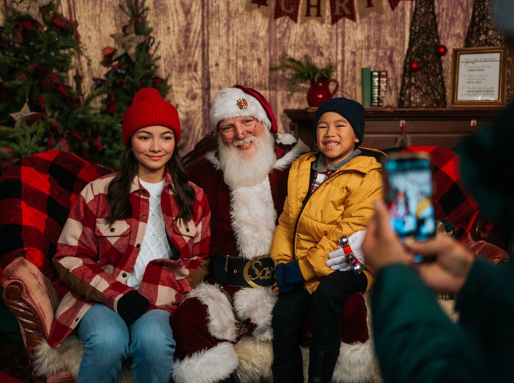 Two kids meet Santa Clause at the Banff Christmas Market during Christmas in Banff.